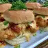 Bang Bang Chicken Sliders served on a platter with garnishes